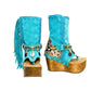 Handmade Atenea Turquoise Flip Flop Boots by Sol Caleyo, featuring vibrant turquoise suede, bohemian fringes, shell embellishments, and a tall wooden platform.