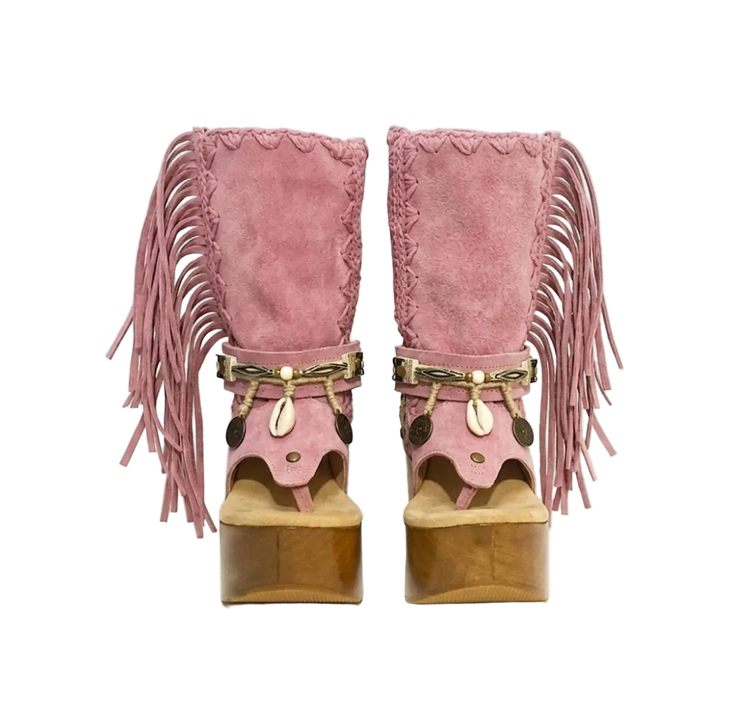 Handmade Atenea Pink Flip Flop Boots by Sol Caleyo, featuring pink suede leather, fringe details, shells, vintage coins, and a high wooden platform sole on a white background