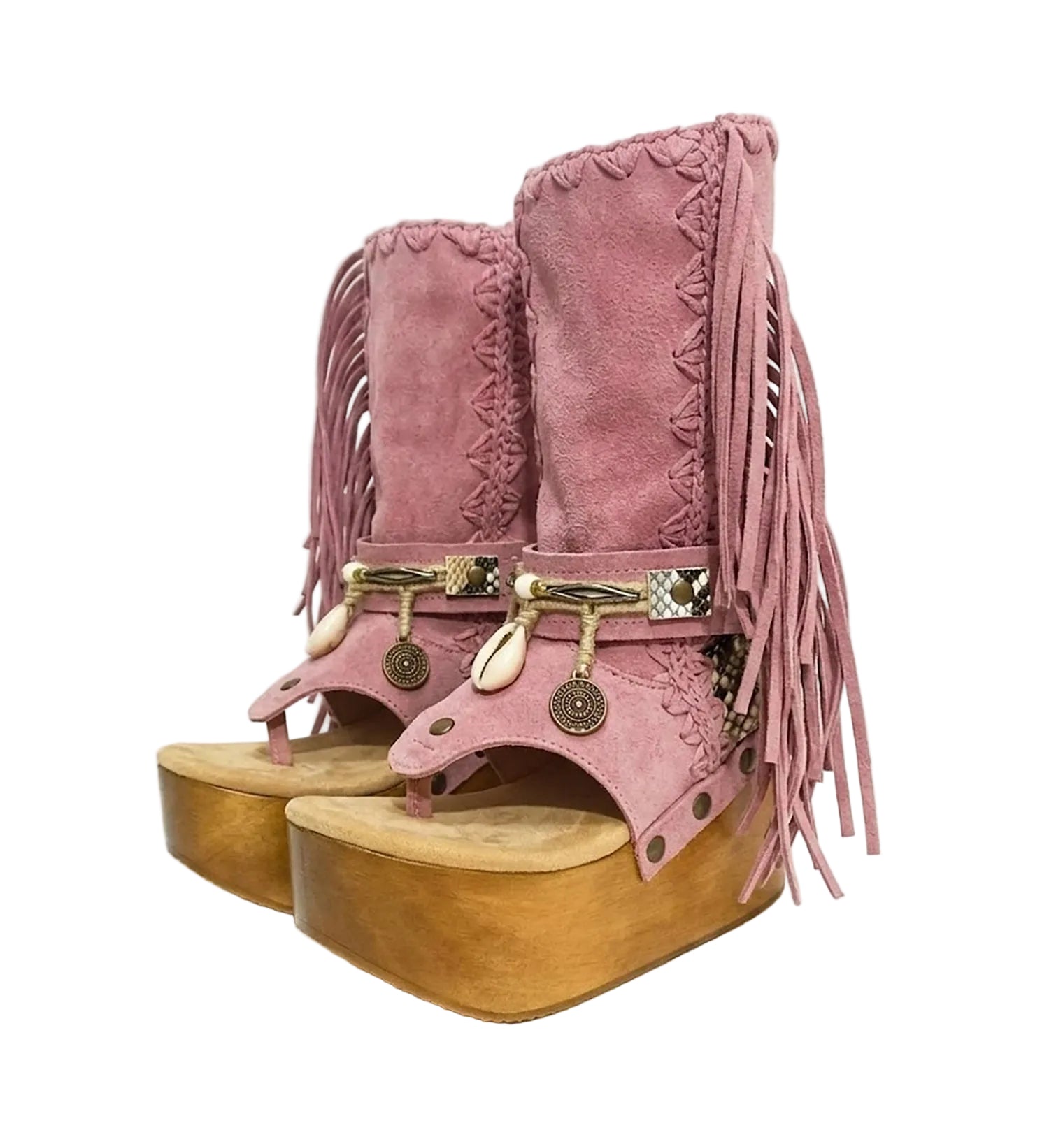 Handmade Atenea Pink Flip Flop Boots by Sol Caleyo, featuring pink suede leather, fringe details, shells, vintage coins, and a high wooden platform sole on a white background