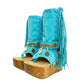 Handmade Atenea Turquoise Flip Flop Boots by Sol Caleyo, featuring vibrant turquoise suede, bohemian fringes, shell embellishments, and a tall wooden platform.