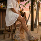 Model at a beach club wearing Atenea beige suede platform boots, showing the natural earthy tones and bohemian details in a sophisticated summer sunset setting
