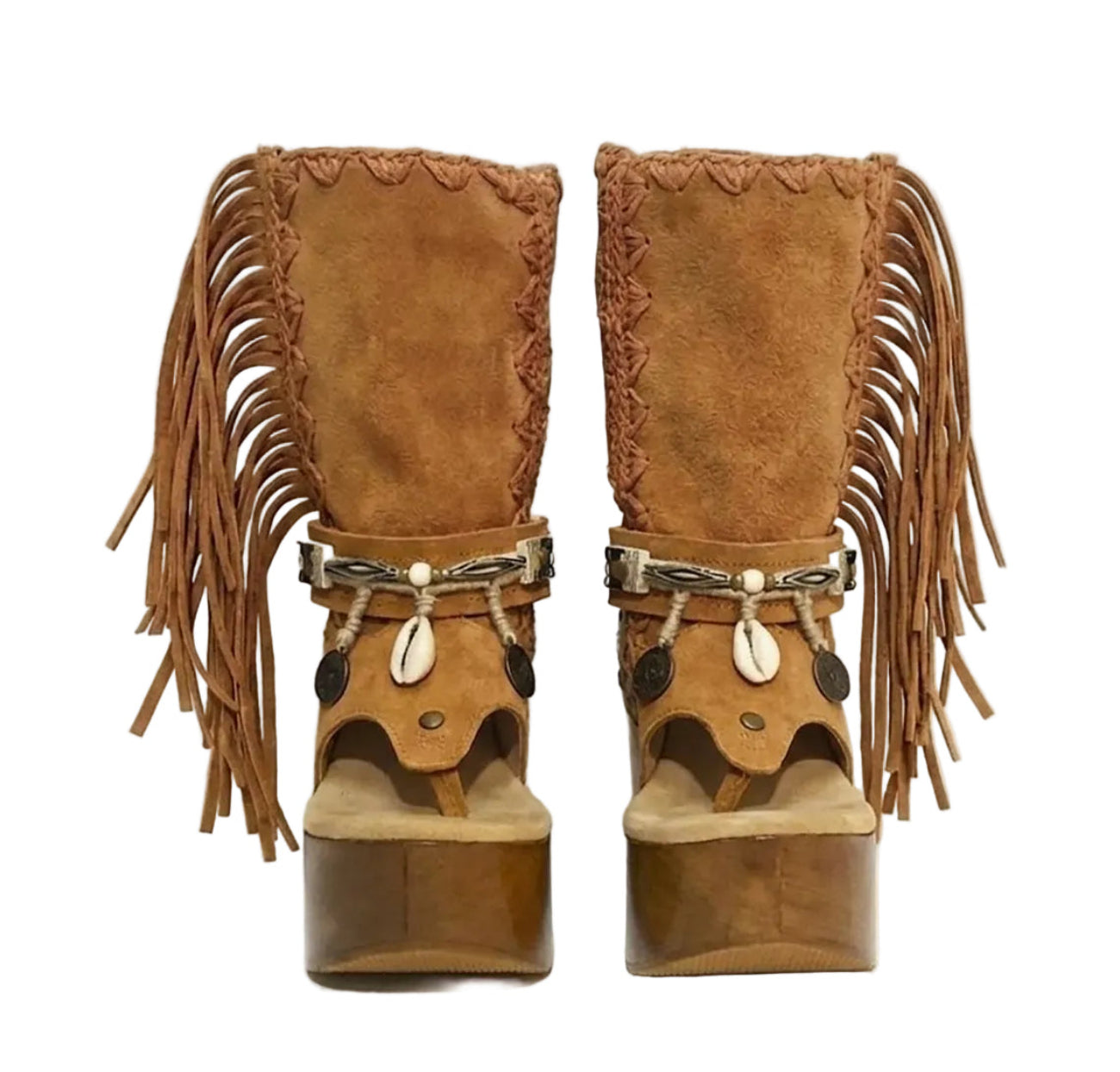Handmade Atenea Camel Flip Flop Boots by Sol Caleyo, featuring warm camel-colored suede, bohemian fringes, shell embellishments, snake-print details, and a high wooden platform sole on a white background.