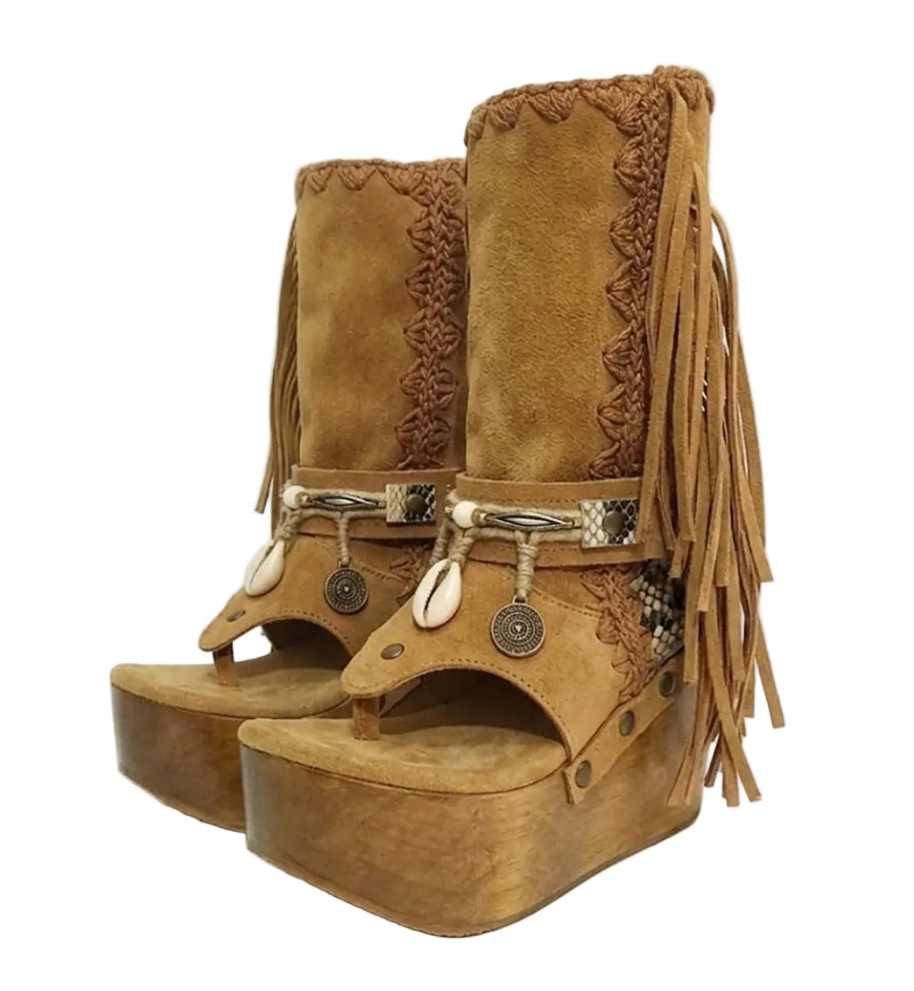 Handmade Atenea Camel Flip Flop Boots by Sol Caleyo, featuring warm camel-colored suede, bohemian fringes, shell embellishments, snake-print details, and a high wooden platform sole on a white background.