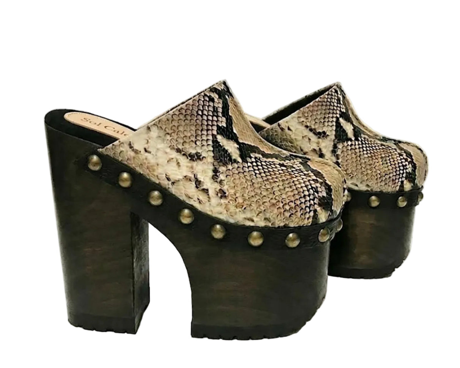 Handmade Tokio Snake Clogs by Sol Caleyo, featuring exotic python-print leather, an 18cm dark wenge-colored wooden platform, old gold-toned studs, and a black tractor sole on a white background.