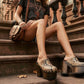 Model walking in New York City wearing the exotic Tokio Snake Clogs by Sol Caleyo, showcasing the python-print leather and high wenge platform against an urban brownstone backdrop.