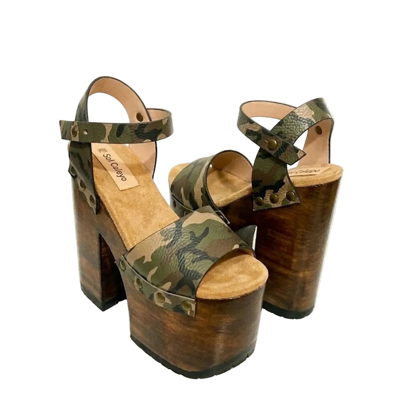 Side view of Crazy Armi Sandals by Sol Caleyo, featuring a 17 cm wooden heel, camouflage leather straps, and brass stud details on a white background.