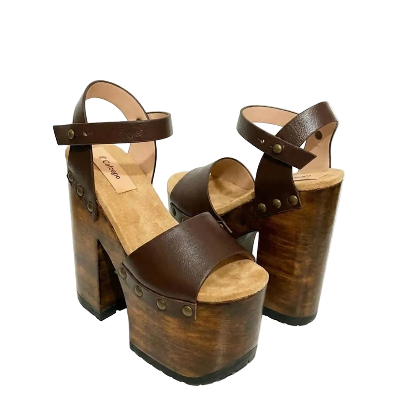 Side view of Sol Caleyo Crazy Brown Sandals featuring deep brown leather straps, ankle closure, and a 17 cm hand-carved wooden platform heel with bronze studs.