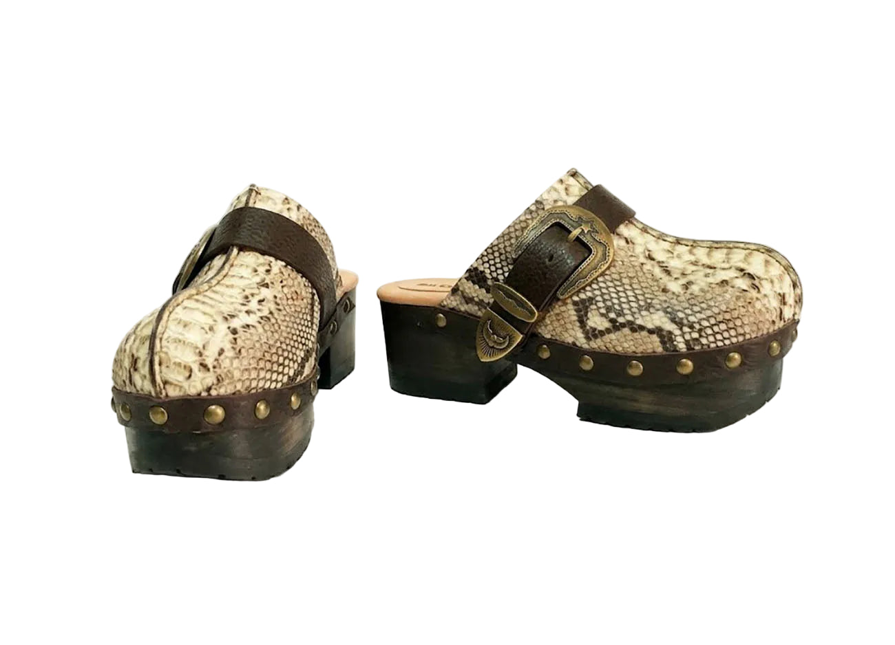 Handmade snake print leather clogs with brown leather strap and antique gold buckle on a wooden platform sole.