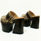 High-angle view of Route 66 XL snake print leather clogs featuring an extreme 17cm wooden heel and 11cm platform.