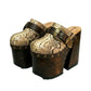 High-angle view of Route 66 XL snake print leather clogs featuring an extreme 17cm wooden heel and 11cm platform.