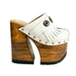 Side view of White Indian Clogs XL featuring extreme 17cm natural wood platform, white leather fringes, and antique silver metal conchos.