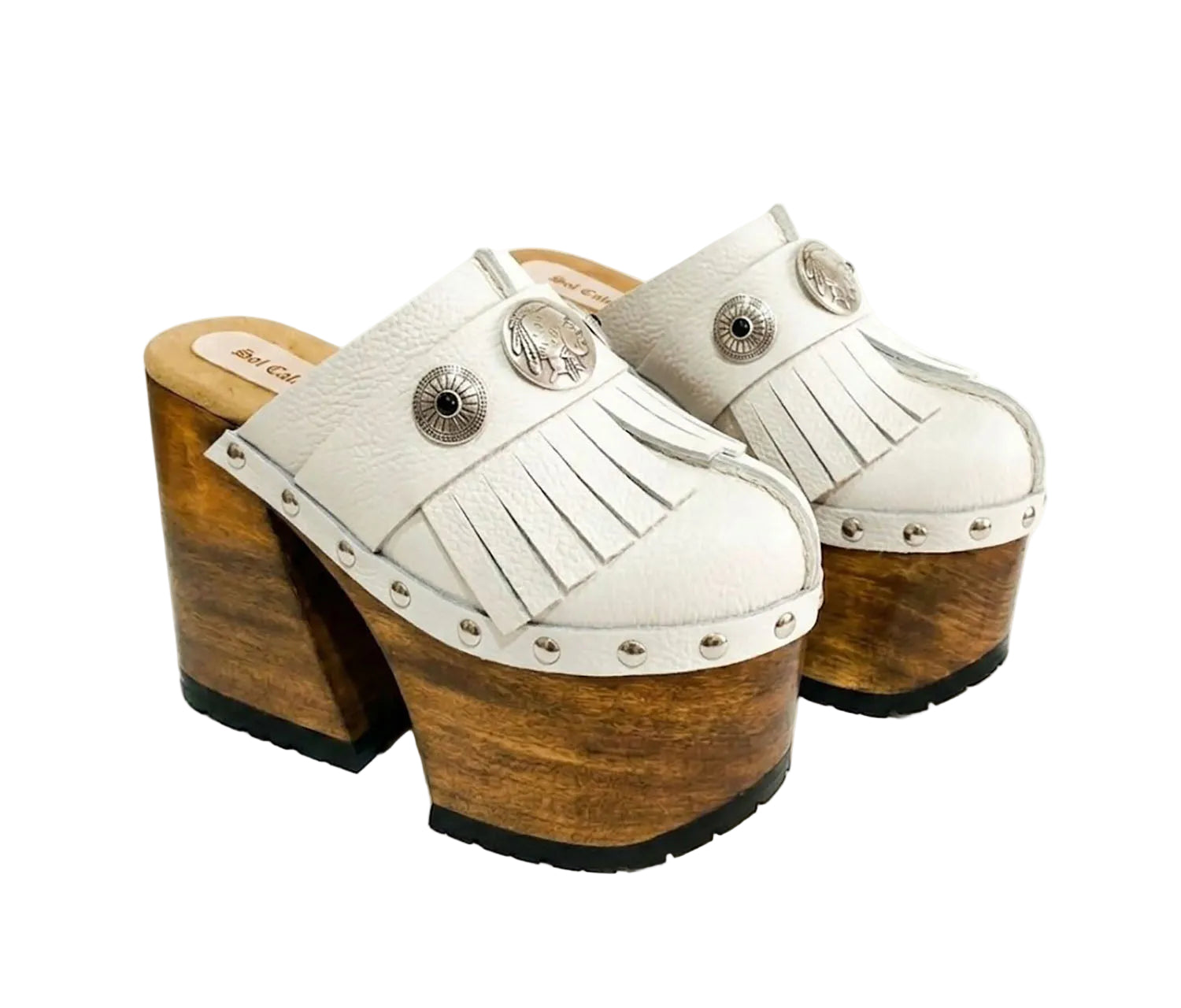 Side view of White Indian Clogs XL featuring extreme 17cm natural wood platform, white leather fringes, and antique silver metal conchos.