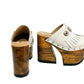 Side view of White Indian Clogs XL featuring extreme 17cm natural wood platform, white leather fringes, and antique silver metal conchos.
