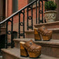 Side profile of Sol Caleyo Light Brown Indian Clogs XL featuring a high 17cm wooden platform, textured brown leather, decorative fringes, and antique metal conchos on a white background.