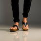 Men’s handmade black leather clogs with wooden sole, artisan flip-flop style sandals by Sol Caleyo.