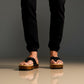 Men’s handmade black leather clogs with wooden sole, artisan flip-flop style sandals by Sol Caleyo.