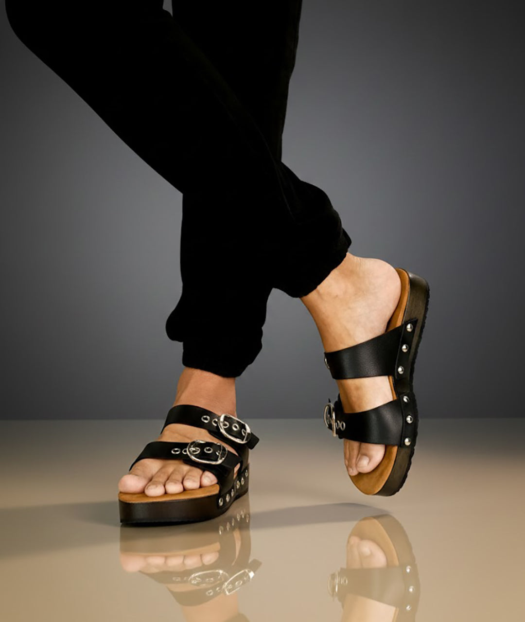 Handmade men’s black leather Birk sandals with wooden sole and black Vibram outsole by Sol Caleyo.