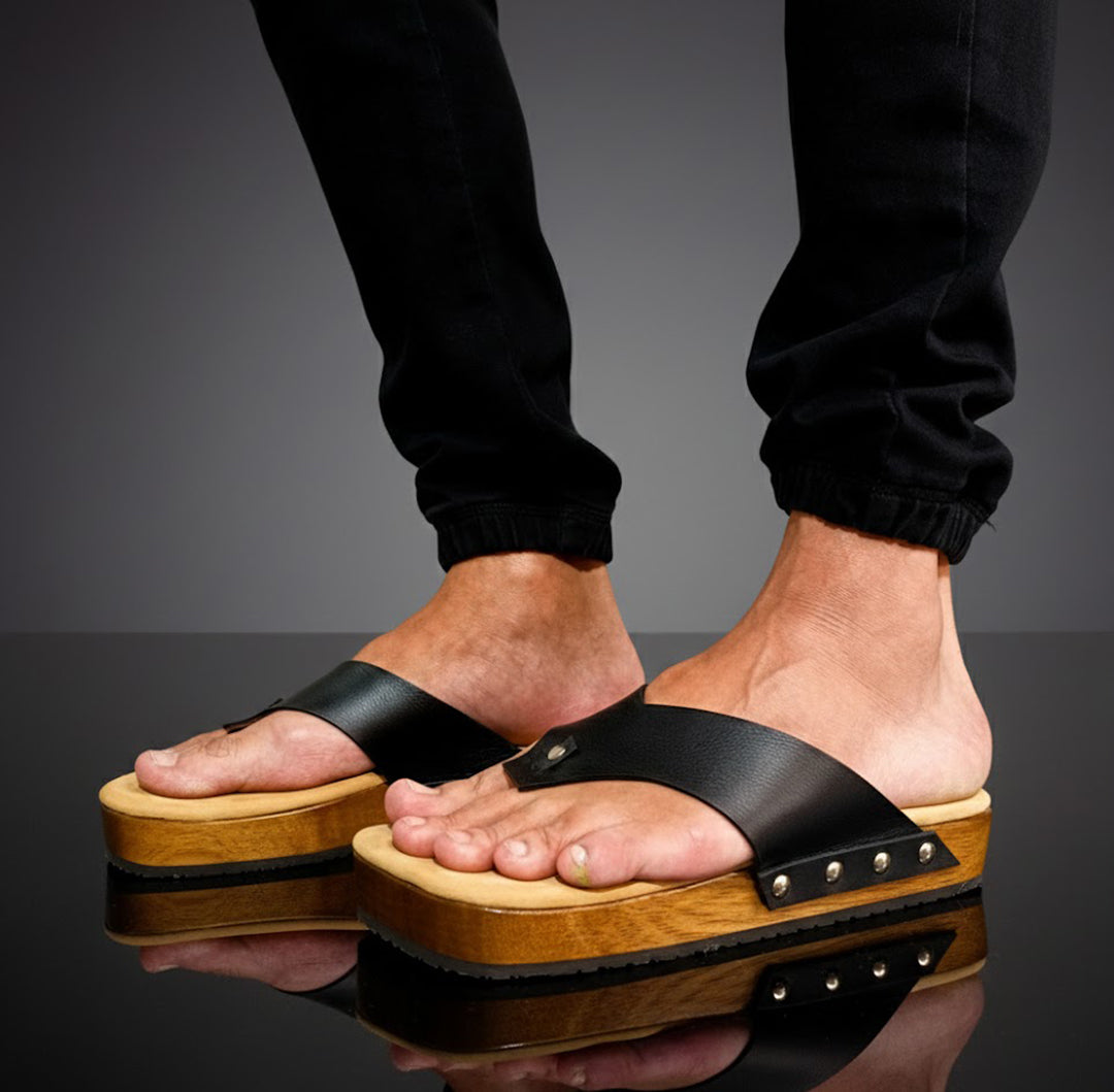 Black leather handcrafted men’s sandals with flat wooden sole and comfortable open clog design.