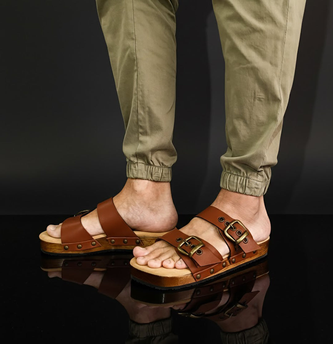 Man wearing handmade brown leather wooden sole sandals outdoors, showing fit and rugged style.