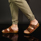 Man wearing handmade brown leather wooden sole sandals outdoors, showing fit and rugged style.