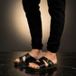 Man wearing handmade black leather wooden sole sandals outdoors, showing fit and rugged style.