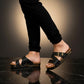 Man wearing handmade black leather wooden sole sandals outdoors, showing fit and rugged style.