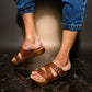 Man wearing handmade brown leather wooden sole sandals outdoors, showing fit and rugged style.