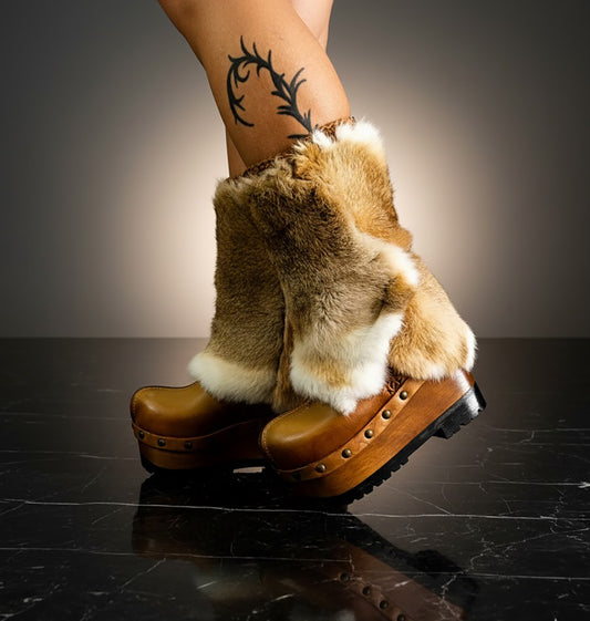 Person wearing handmade beige leather and fur platform boots, showing fit and bohemian style.