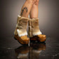 Person wearing handmade beige leather and fur platform boots, showing fit and bohemian style.