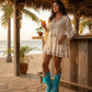 Handmade Rhapsody turquoise suede boho boots by Sol Caleyo featuring natural feathers, horns, and shells on a 12cm wooden platform with a black tractor sole.