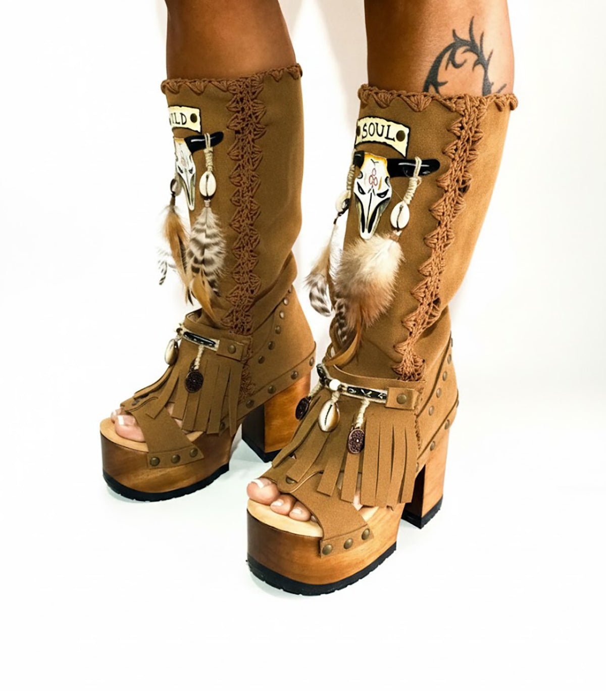 Handmade Sol Caleyo buffalo platform sandals in premium suede with 12cm sculpted wooden sole. Artisan boho-chic footwear featuring hand-painted motifs, natural shells, and feathers. Sustainable slow fashion shoes, custom-made in sizes 34-47.