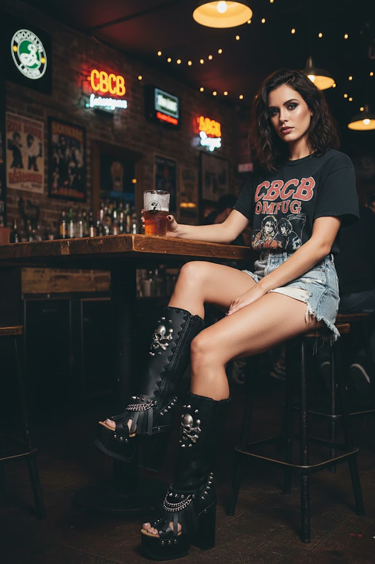 Handcrafted Sol Caleyo black leather boots featuring a wenge wooden platform, embellished with old silver skulls, chains, and fringes in a gothic-chic style.