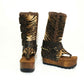 Close-up of Alabama Flip Flops Tiger Boots by Sol Caleyo. Features tiger-print premium leather, old gold pyramid studs, and a 10cm wooden wedge with black Vibram tractor soles.