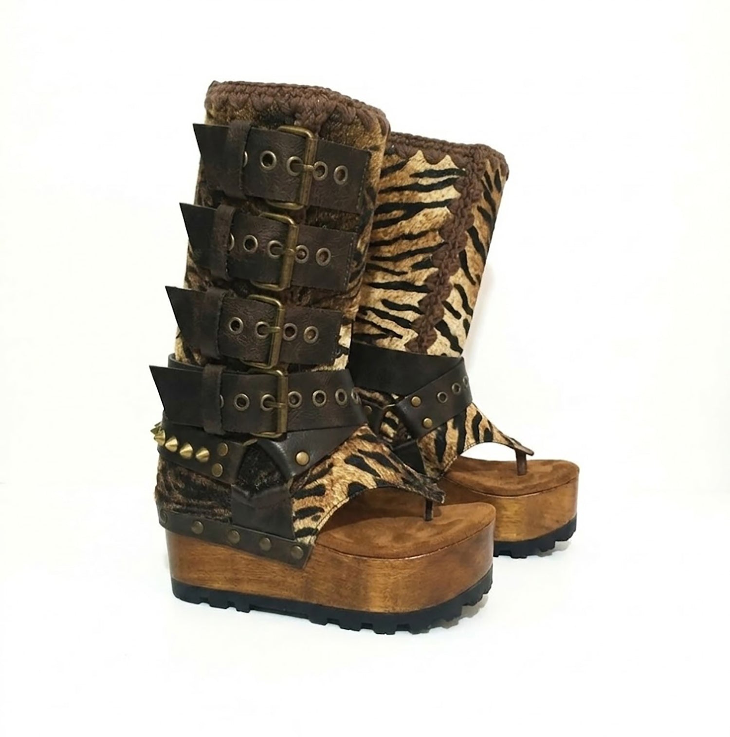 Close-up of Alabama Flip Flops Tiger Boots by Sol Caleyo. Features tiger-print premium leather, old gold pyramid studs, and a 10cm wooden wedge with black Vibram tractor soles.