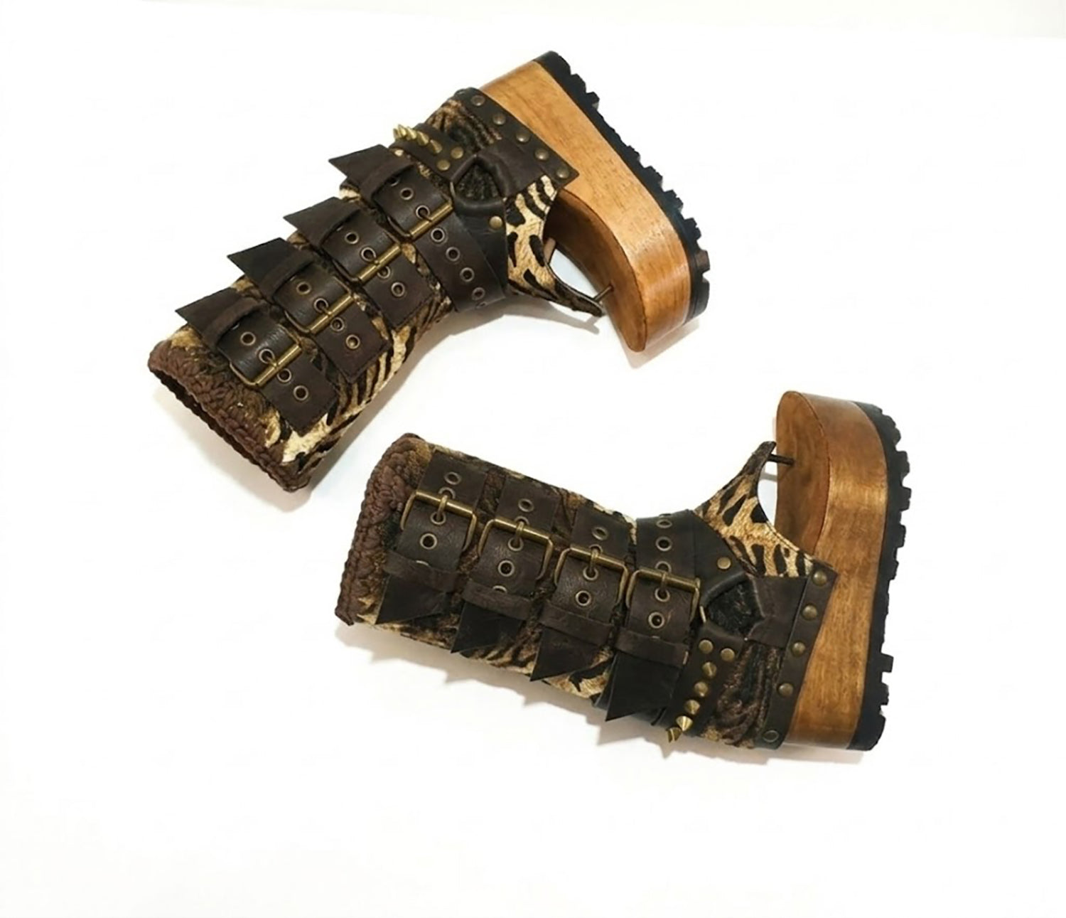 Close-up of Alabama Flip Flops Tiger Boots by Sol Caleyo. Features tiger-print premium leather, old gold pyramid studs, and a 10cm wooden wedge with black Vibram tractor soles.