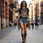 Model wearing Alabama Tiger Boots with tiger-print leather and biker-style buckles. High-end artisanal wedge boots styled for a bold, rebellious fashion look by Sol Caleyo.