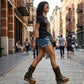 Model wearing Alabama Tiger Boots with tiger-print leather and biker-style buckles. High-end artisanal wedge boots styled for a bold, rebellious fashion look by Sol Caleyo.