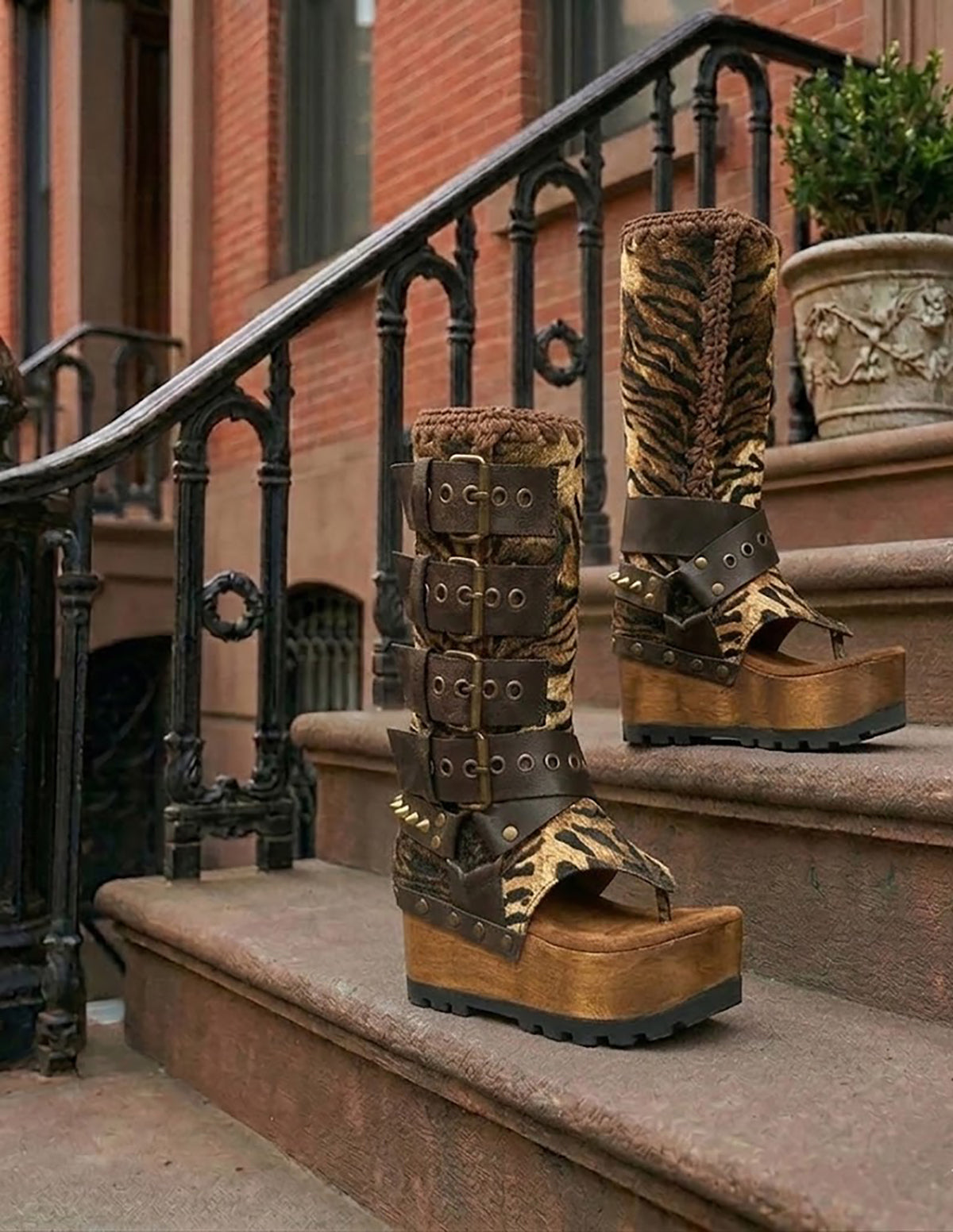 Close-up of Alabama Flip Flops Tiger Boots by Sol Caleyo. Features tiger-print premium leather, old gold pyramid studs, and a 10cm wooden wedge with black Vibram tractor soles.