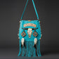 Bohemian-style turquoise  leather bag. Handmade leather bag with hand-painted buffalo decorated with shells, feathers, carved horn, and felcos. Handmade leather bag by Sol Caleyo.