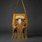 Bohemian-style camel  leather bag. Handmade leather bag with hand-painted buffalo decorated with shells, feathers, carved horn, and felcos. Handmade leather bag by Sol Caleyo.