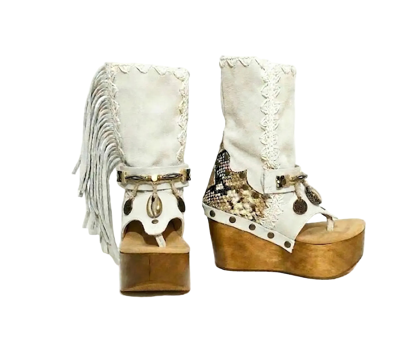 Atenea White Flip Flop Boots by Sol Caleyo, featuring premium white suede, bohemian fringe, shell decorations, and a chunky wooden platform heel against a white background.
