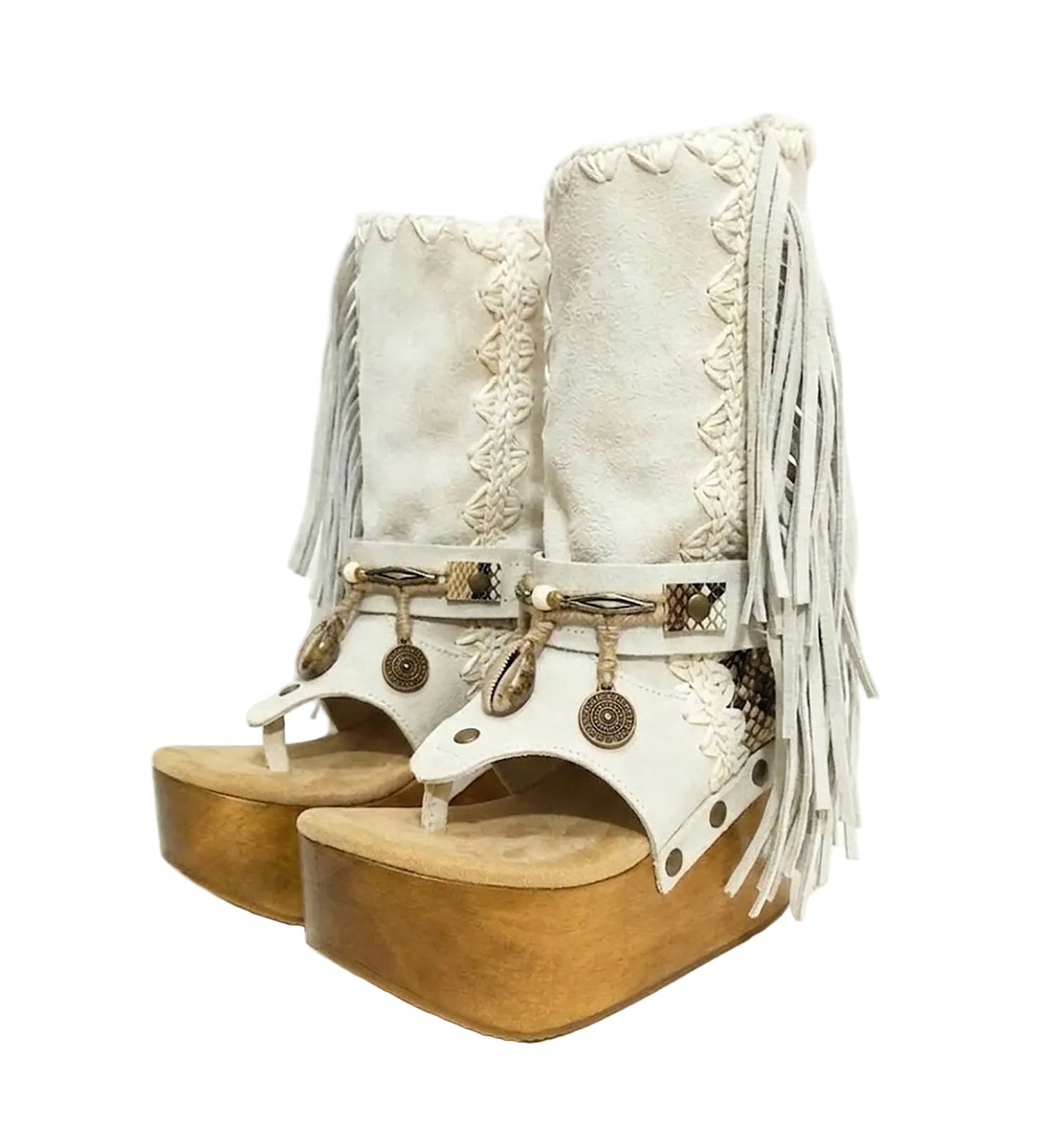 Atenea White Flip Flop Boots by Sol Caleyo, featuring premium white suede, bohemian fringe, shell decorations, and a chunky wooden platform heel against a white background.