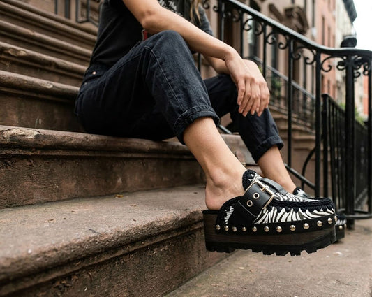 Model wearing Sol Caleyo Zebra Oxford Clogs with a 6 cm heel and 5 cm platform, showcasing the zebra-patterned leather and sophisticated bohemian style.