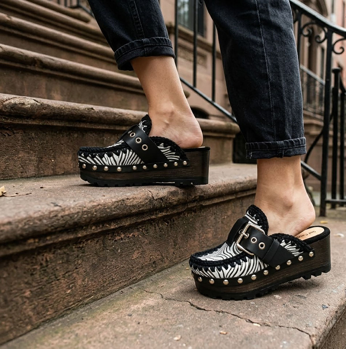 Model wearing Sol Caleyo Zebra Oxford Clogs with a 6 cm heel and 5 cm platform, showcasing the zebra-patterned leather and sophisticated bohemian style.