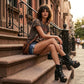 Model wearing Sol Caleyo bohemian leather platform sandals with wooden heel and silver decorative studs. High-end boho-chic summer outfit featuring artisan handcrafted footwear.