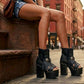 Model wearing Sol Caleyo bohemian leather platform sandals with wooden heel and silver decorative studs. High-end boho-chic summer outfit featuring artisan handcrafted footwear.