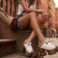 White leather sandal. White leather sandal boho style. White leather sandal decorated with fringes and silver conchos with a unique boho style. Wooden clog sandals with super high heels 70's style. Sizes 34 to 47. High quality handmade leather shoes by sol Caleyo. Sustainable fashion.