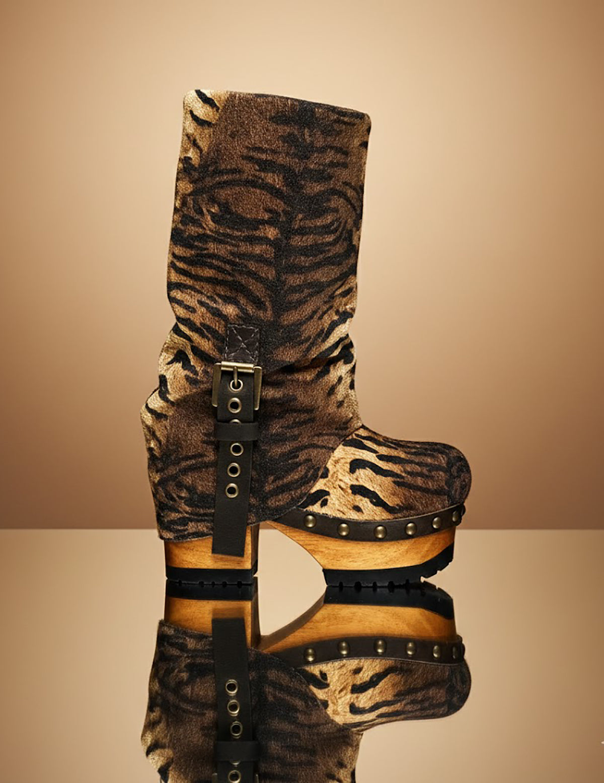 Sol Caleyo Tiger Boots - Handcrafted tiger-print suede boots with 3.5-inch wooden platform and antique gold buckle.