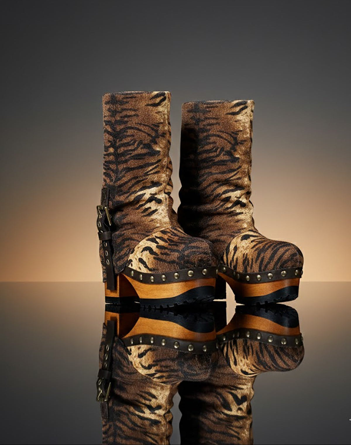 Sol Caleyo Tiger Boots - Handcrafted tiger-print suede boots with 3.5-inch wooden platform and antique gold buckle.