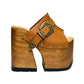 Sol Caleyo handmade Western platform clogs in premium camel leather with 17cm wooden heel and antique-brass concho buckle details.
